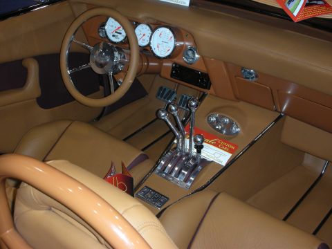 1998 Ford Crown Victoria - Interior view of a custom car tan upholstery, a prominent four-speed shifter, and large, clear gauges.