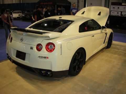 1998 Ford Crown Victoria - A white Nissan GT-R is displayed with its hood open, revealing the engine bay.