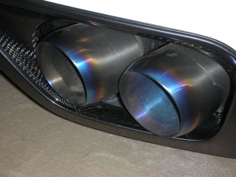 1998 Ford Crown Victoria - Close-up of dual exhaust tips showing iridescent blue and purple heat discoloration.