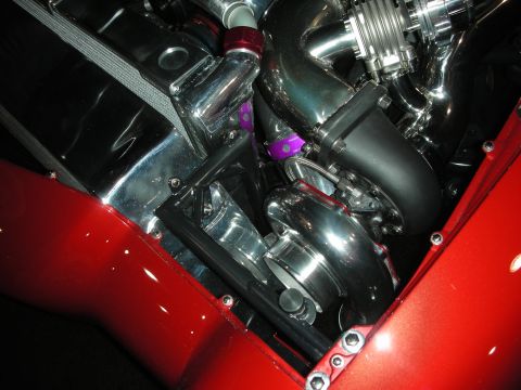 1998 Ford Crown Victoria - Close-up view of a custom engine bay twin turbochargers and polished aluminum intercooler piping.