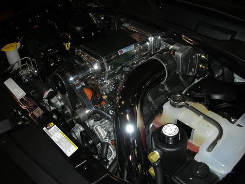 1998 Ford Crown Victoria - Close-up view of a vehicle's engine compartment, highlighting a polished supercharger and associated components.