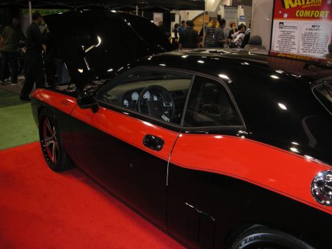 1998 Ford Crown Victoria - A two-door coupe with a black and red paint scheme is displayed indoors with its hood open.