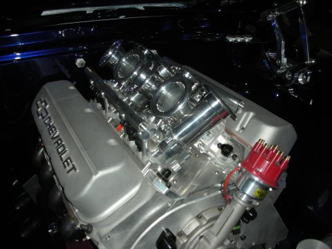 1998 Ford Crown Victoria - Close-up of a Chevrolet V8 engine, individual throttle bodies and a red distributor.