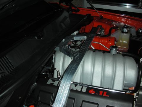 1998 Ford Crown Victoria - Close-up of an engine bay with HEMI 6.1L branding and a strut tower brace installed.
