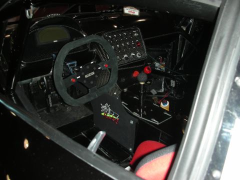 1998 Ford Crown Victoria - Interior view of a modified vehicle, likely a race car, a Sparco steering wheel and racing seat.