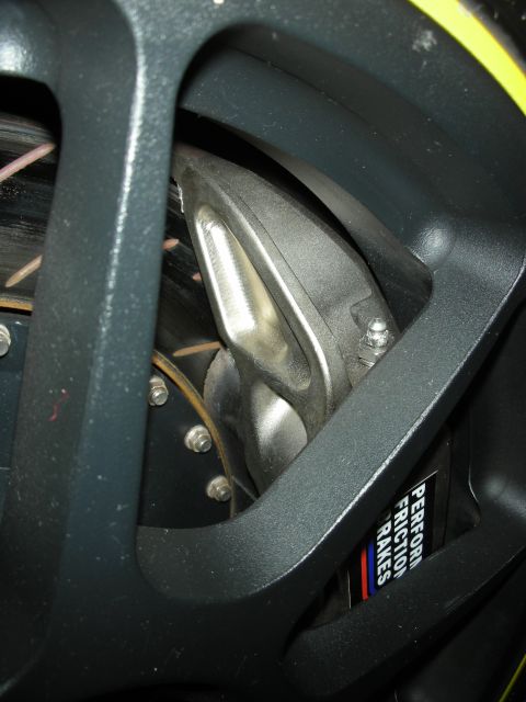 1998 Ford Crown Victoria - Close-up view of a performance brake caliper and rotor assembly.