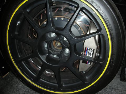 1998 Ford Crown Victoria - A performance brake caliper and wheel assembly is shown, a yellow stripe on the tire and prominent branding on the caliper.