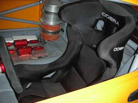 1998 Ford Crown Victoria - The interior of a race car features Cobra racing seats and visible fuel system components, suggesting a performance-oriented build.