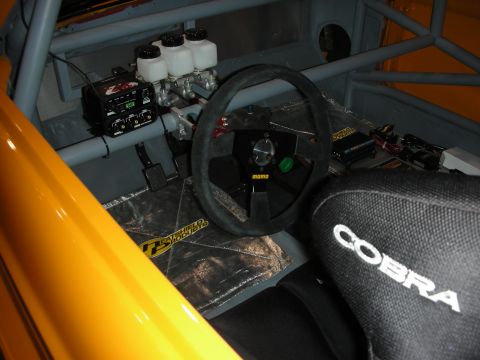 1998 Ford Crown Victoria - Interior view of a racing car, showing the steering wheel, seat, and brake system components.