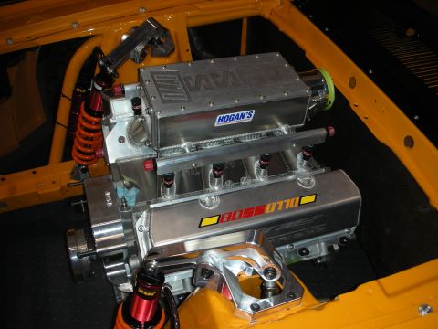 1998 Ford Crown Victoria - A custom V8 engine with "BOSS 0770" and "HOGAN'S" branding is installed in a yellow chassis.