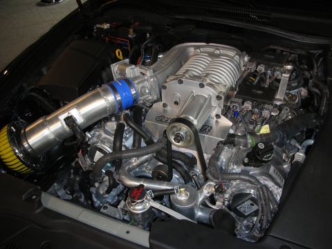 1998 Ford Crown Victoria - Close-up view of a modified engine bay, highlighting a prominent supercharger and intake system.
