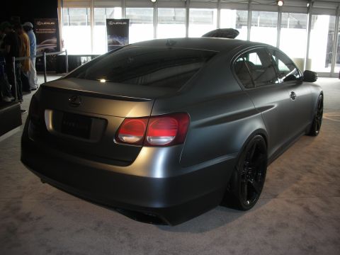 1998 Ford Crown Victoria - A matte gray Lexus GS sedan is displayed indoors, likely at a car show.