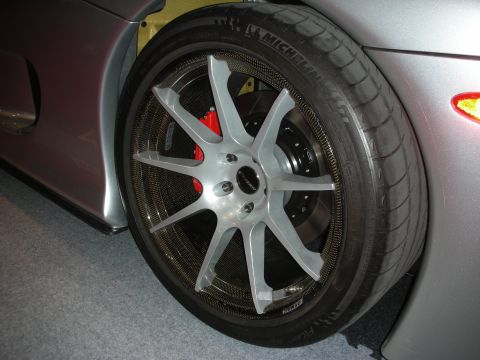 1998 Ford Crown Victoria - Close-up of a custom silver wheel with carbon fiber accents and red brake caliper on a silver vehicle.