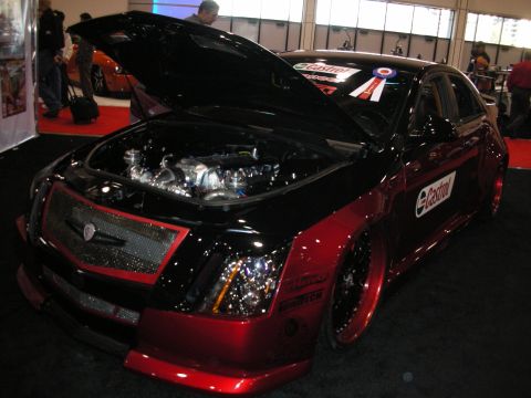 1998 Ford Crown Victoria - Customized Cadillac CTS with engine exposed and Castrol branding on the side.