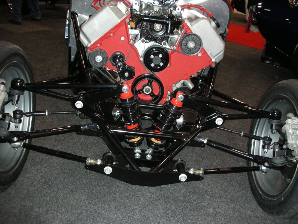 Custom vehicle front suspension with red engine block and black components