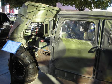 1998 Ford Crown Victoria - A military vehicle with its hood open, revealing the engine compartment and a PPE Diesel label on the side.