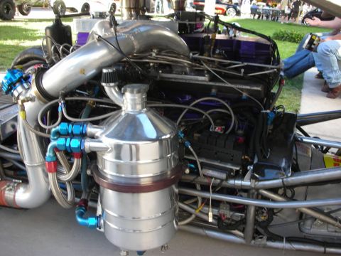 1998 Ford Crown Victoria - Customized engine bay with prominent chrome tank and turbocharger components.