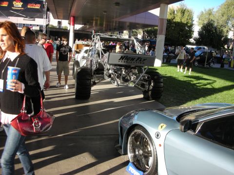 1998 Ford Crown Victoria - A custom buggy and a light blue sports car are on display at an outdoor event.