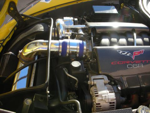 1998 Ford Crown Victoria - Engine bay details of a Corvette C6R, chrome piping and carbon fiber engine covers.