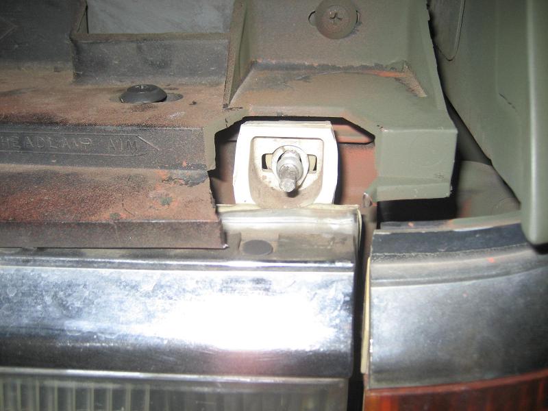 Headlight mounting bracket with visible text 'HEADLAMP AIM'