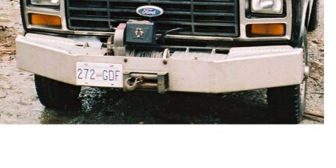 1985 Ford Bronco - Two storage compartments, one on either side of the winch, for whatever. Wingnuts keep closed while bouncing around.