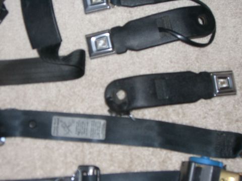 1988 Ford Bronco - Multiple seat belts are shown, including one with a visible label and metal buckles.