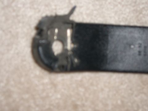 1988 Ford Bronco - Close-up of a black seatbelt buckle mechanism, showing its internal metal parts.