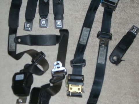 1988 Ford Bronco - Collection of seat belts and buckles, likely for interior restoration or replacement.