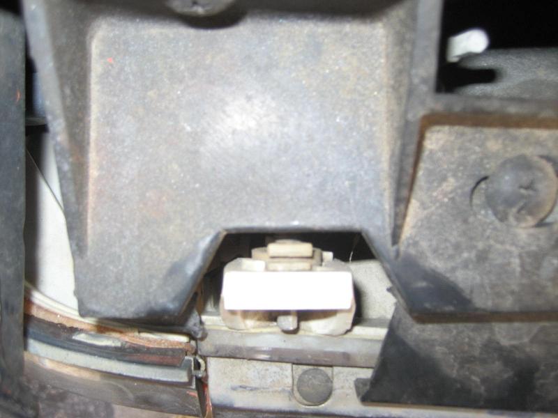 Headlight mounting bracket with white plastic clip and metal screws