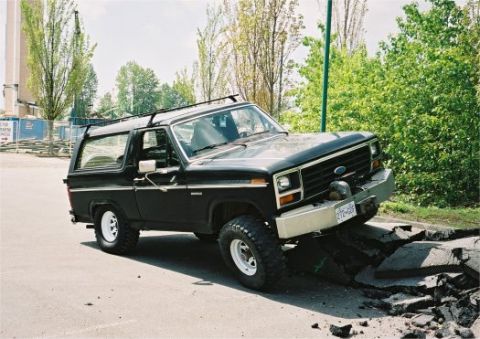 1985 Ford Bronco - This 1985 Ford Bronco navigates a damaged section of pavement.