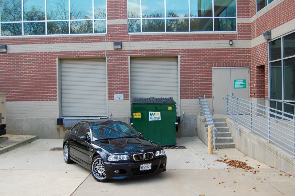 Black 2002 BMW M3 3q-front view parked by loading dock