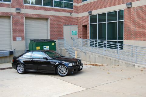 2002 BMW M3 - Black 2002 BMW M3 parked outside a commercial building.