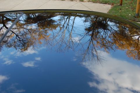 2002 BMW M3 - Reflection of autumn trees and sky on a car's roof.