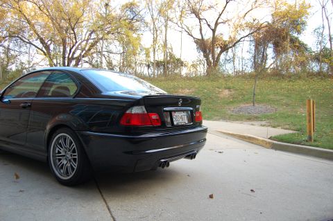 2002 BMW M3 - The rear view of a black coupe shows its distinctive taillights and spoiler.