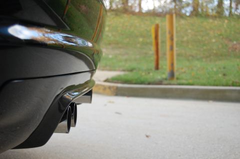 2002 BMW M3 - Close-up of the rear bumper and quad exhaust pipes on a black 2002 BMW M3.