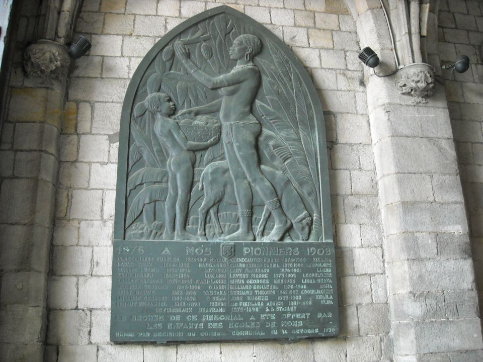 Bronze figural memorial relief plaque mounted on a stone wall