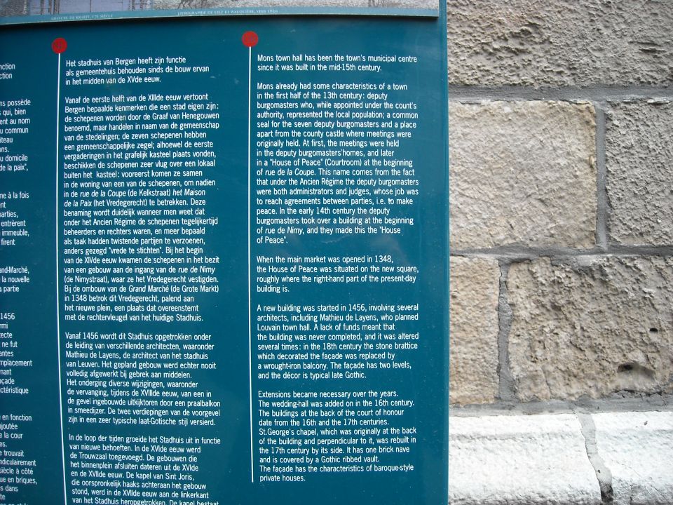 Outdoor tourist information panel with Dutch and English text about Bergen town hall