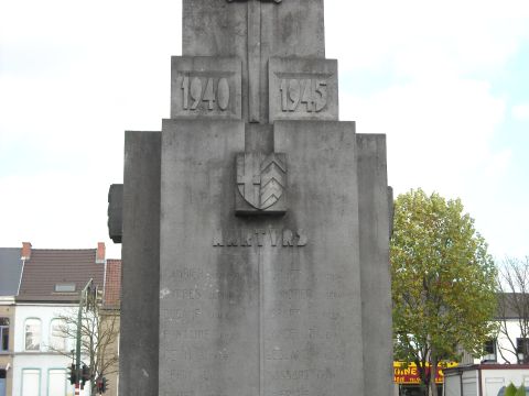 1979 Ford F-150 - A monument commemorating war dates and fallen soldiers stands outdoors with trees and buildings in the background.