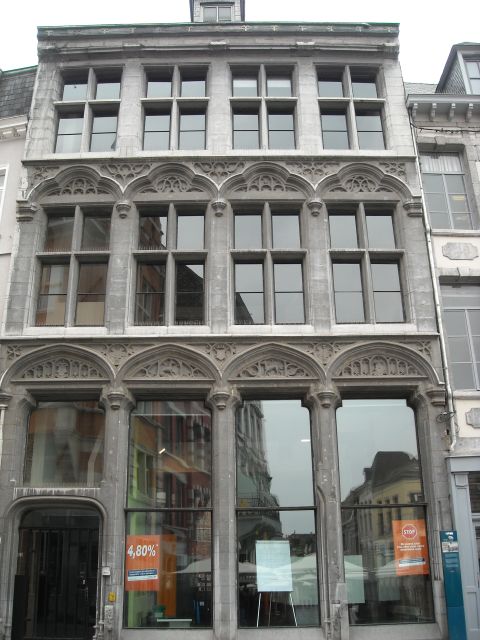 1979 Ford F-150 - A historic stone building facade features intricate architectural details and large windows reflecting the surrounding urban environment.