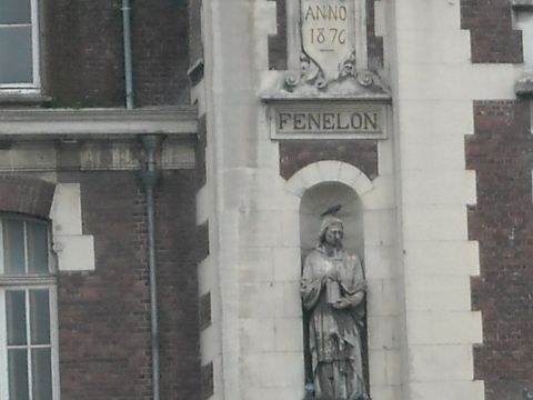 1979 Ford F-150 - A statue of Fenelon, dated 1876, is seen perched on the side of a brick building.