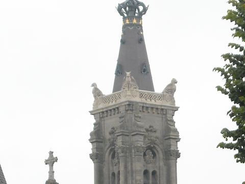 1979 Ford F-150 - A detailed view of an old stone tower, adorned with sculptures and intricate carvings, under a cloudy sky.