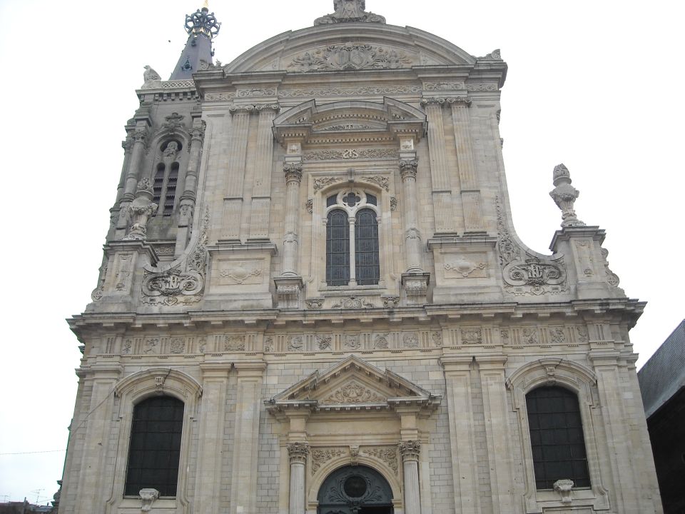 Ornate church facade with arched windows and detailed stonework