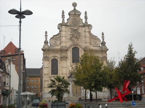 1979 Ford F-150 - A street scene in front of an ornate building, trees and a red sculpture.