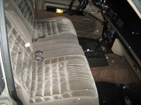 1988 Mercury Grand Marquis - The interior of a car shows velour seats and the dashboard, with a watermark at the bottom right.