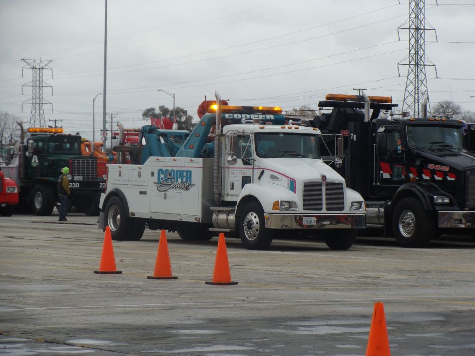 White tow truck with blue crane and Cooper Service logo