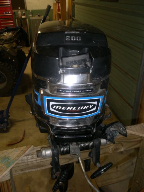 2007 Ford Bronco - A black Mercury outboard motor with blue accents and '200' displayed on the cowling is shown.