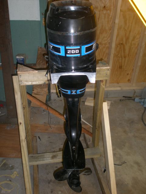 2007 Ford Bronco - Outboard motor with '200' designation displayed on a stand in a workshop.