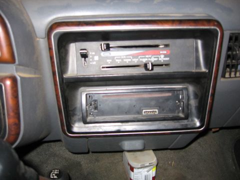 1989 Ford Bronco - Close-up of the climate controls and stereo area in a vehicle's dashboard.