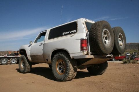 1984 Ford Bronco - This SUV, likely from the 1980s, has a custom rear bumper with two spare tires attached.