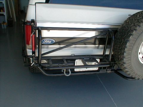 1984 Ford Bronco - This 1984 Ford Bronco features a spare tire mounted on the rear with a custom bumper and roll cage.